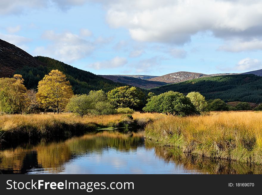 Reflection of the sky and landscape in the river in sunny afternoon. Reflection of the sky and landscape in the river in sunny afternoon