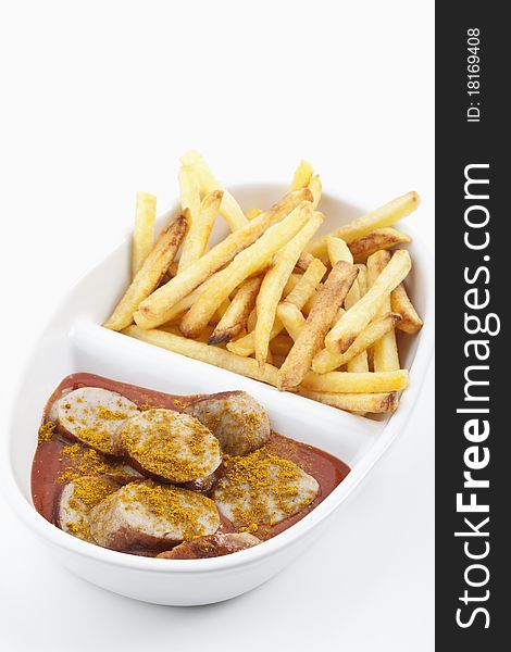 Curried sausages and french fries on a plate