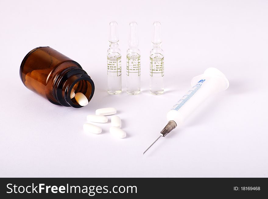 Syringe, vials and bottle with pills. Syringe, vials and bottle with pills