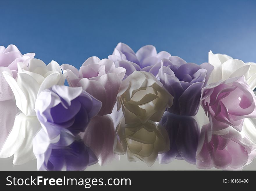 3 different color of flower soaps on the mirror