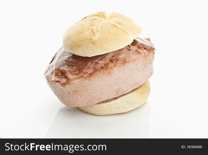 Extra large slice of meatloaf in a bun on white background. Extra large slice of meatloaf in a bun on white background