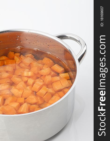 Peaces of carrots in a cooking pot. Peaces of carrots in a cooking pot