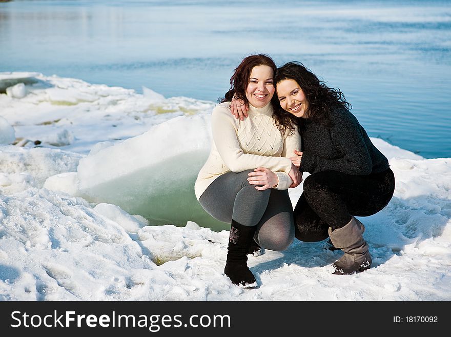 Girls twins near river in winter