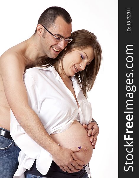 Happy young man and his pregnant wife isolated on white