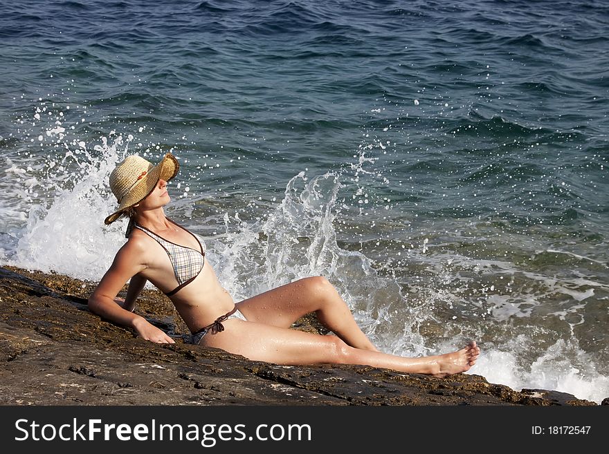Woman with hat sunbathing