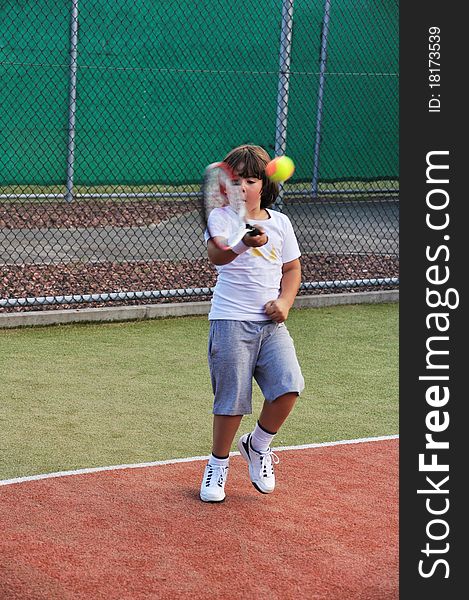Young boy play tennis outdoor