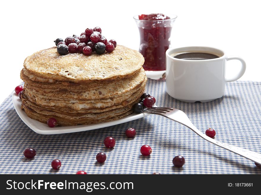 A photo of traditional russian pancakes with berries