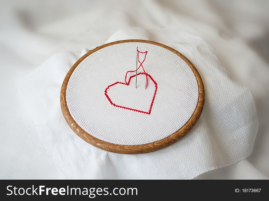 Embroidered red heart on tambour. Embroidered red heart on tambour
