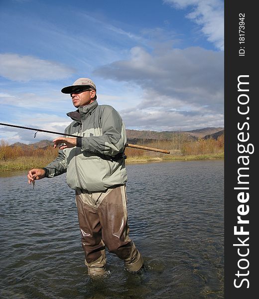 Fishing - fisherman cath on river