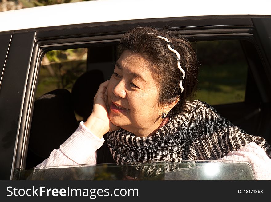 A woman is smiling in the car. A woman is smiling in the car