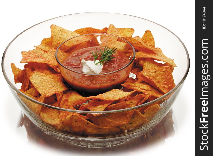 Nacho Chips and Salsa in a glass chip and dip bowl. Nacho Chips and Salsa in a glass chip and dip bowl.