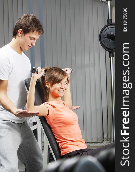 Trainer shows a correct form of exercise. Trainer shows a correct form of exercise