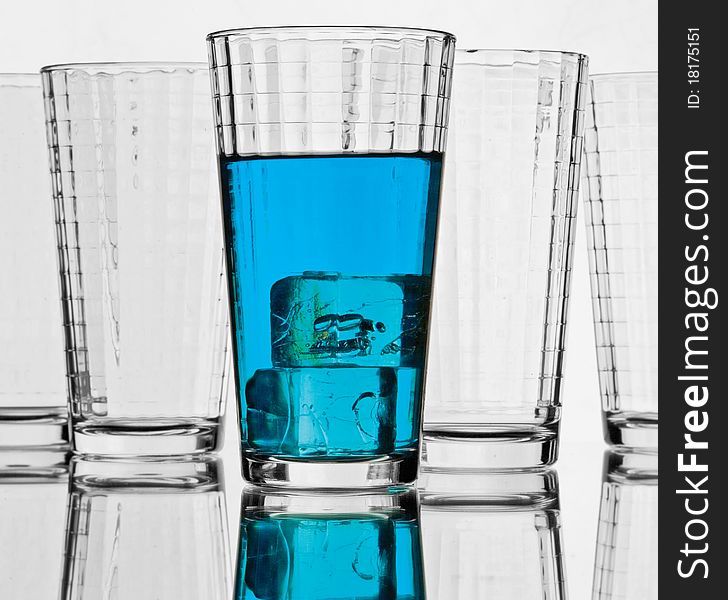 Blue Liquid with ice cube in drinkware glass