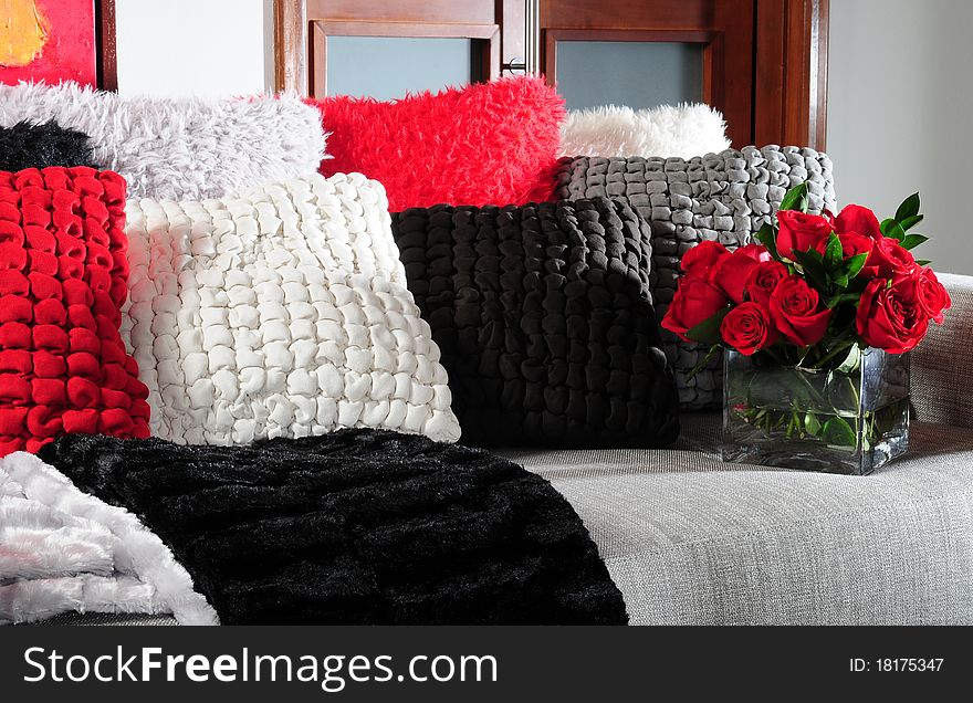 Stack of soft cushions with flowers on couch. Stack of soft cushions with flowers on couch.