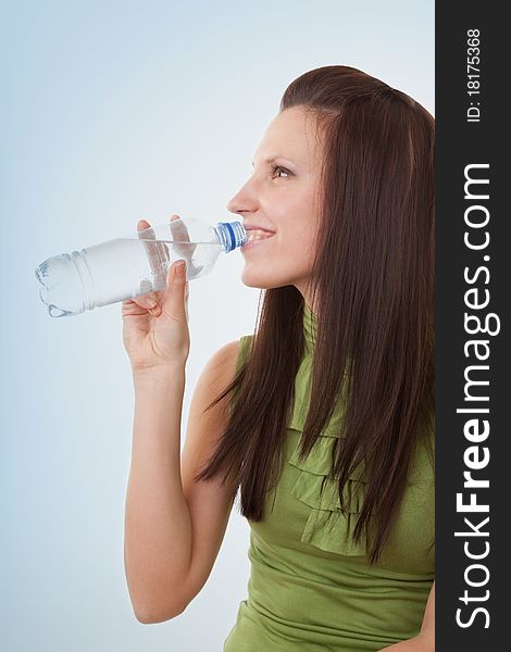 Young woman drinking bottled mineral water. Young woman drinking bottled mineral water