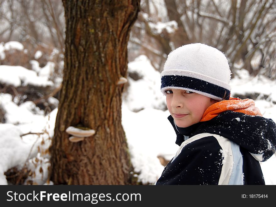 Teenage smiling caucasian boy outdoor over winter snowy background. Teenage smiling caucasian boy outdoor over winter snowy background