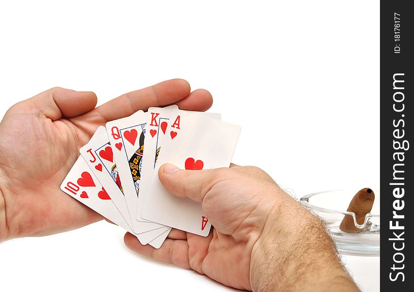 Man's hand lifting up playing cards on white