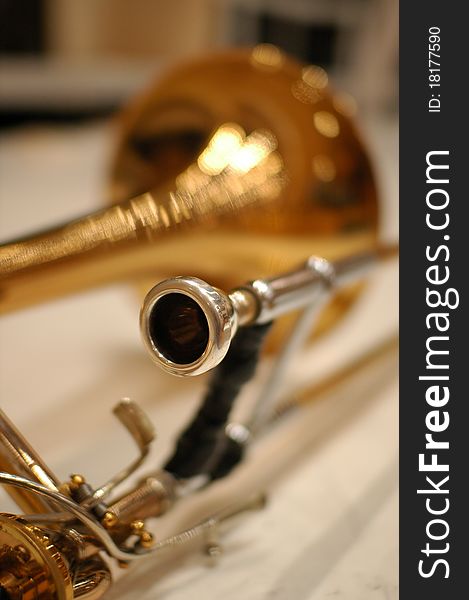 Trombone resting on floor on a rehearsal room.