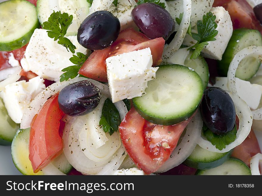 Greek salad inside a white plate and a white background