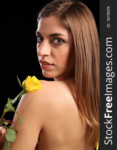 Portrait of beautiful woman with yellow rose