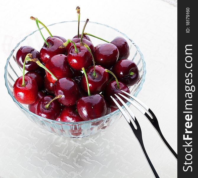 A bowl of fresh cherry with two fruit fork for couple. A bowl of fresh cherry with two fruit fork for couple.