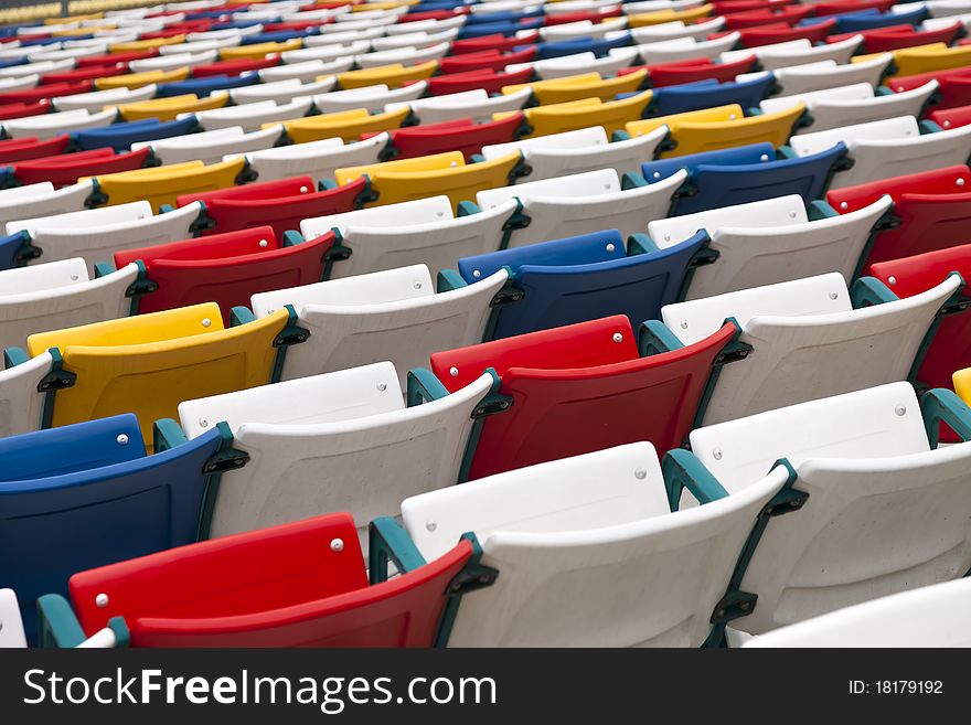 Rows of colored seats at an outdoor venue. Rows of colored seats at an outdoor venue