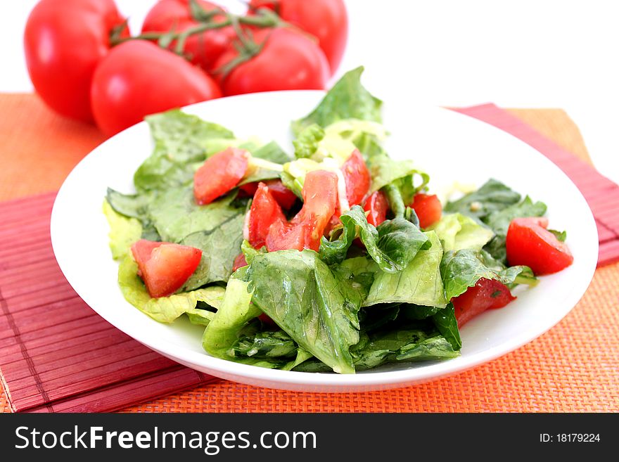 Fresh salad with tomatoes on a plate