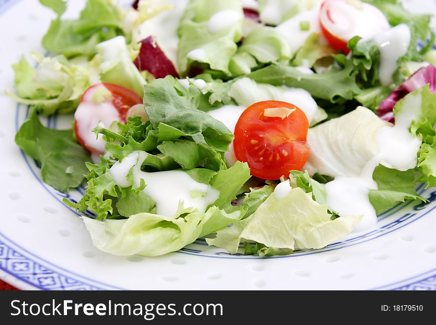 A fresh salad with tomatoes on a plate