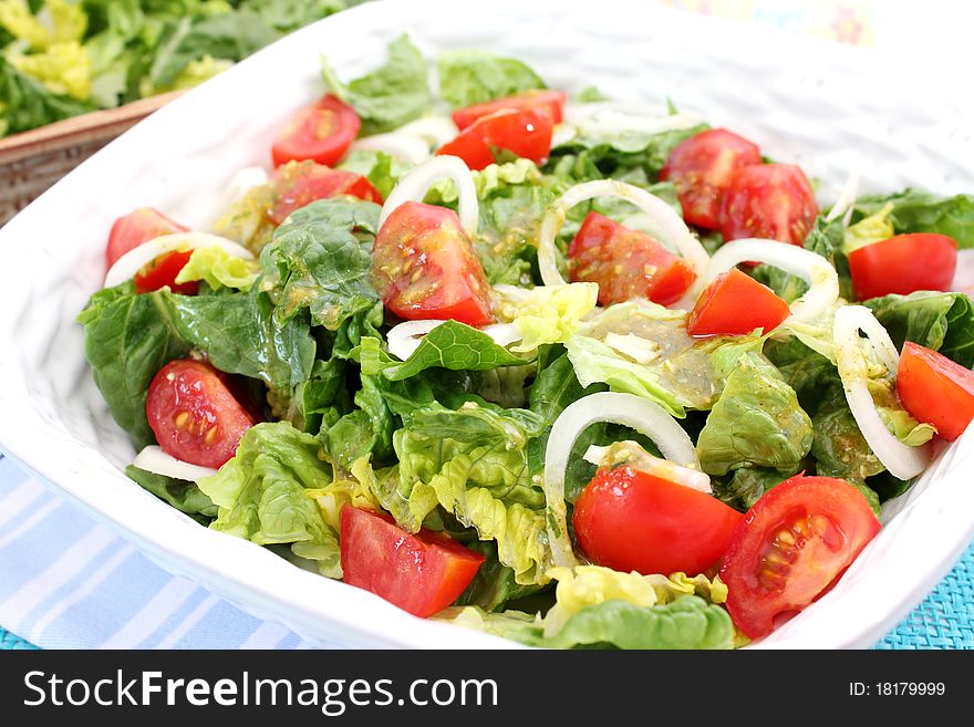 A fresh salad with tomatoes and onions