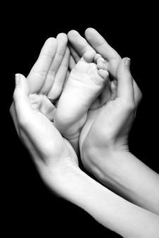 Baby S Feet In Mom S Palms Royalty Free Stock Photos