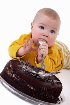 The Baby With A Big Spoon Royalty Free Stock Images