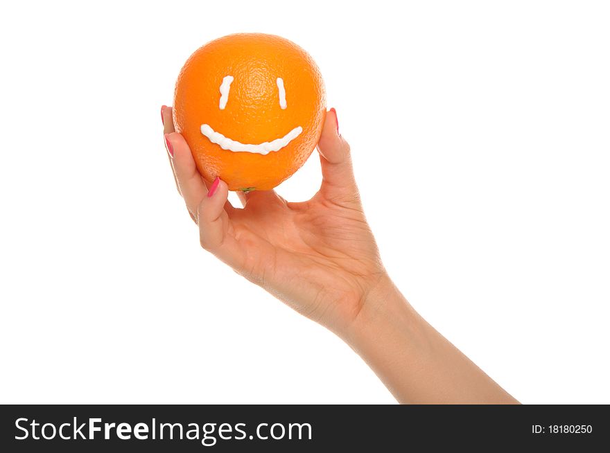 Hand holds orange with drawn smile isolated in white