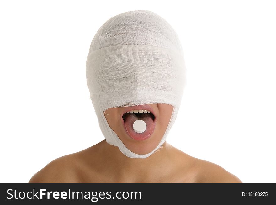 Young woman with bandaged head with tablet in tongue isolated in white