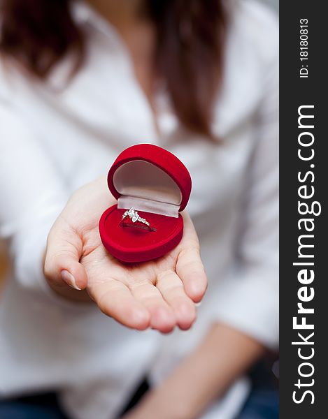 An image of red box with engagement ring inside