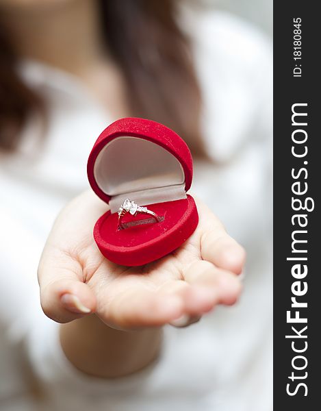 An image of red box with engagement ring inside