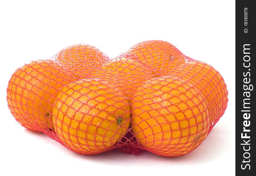 Seven oranges in a red net isolated on white background