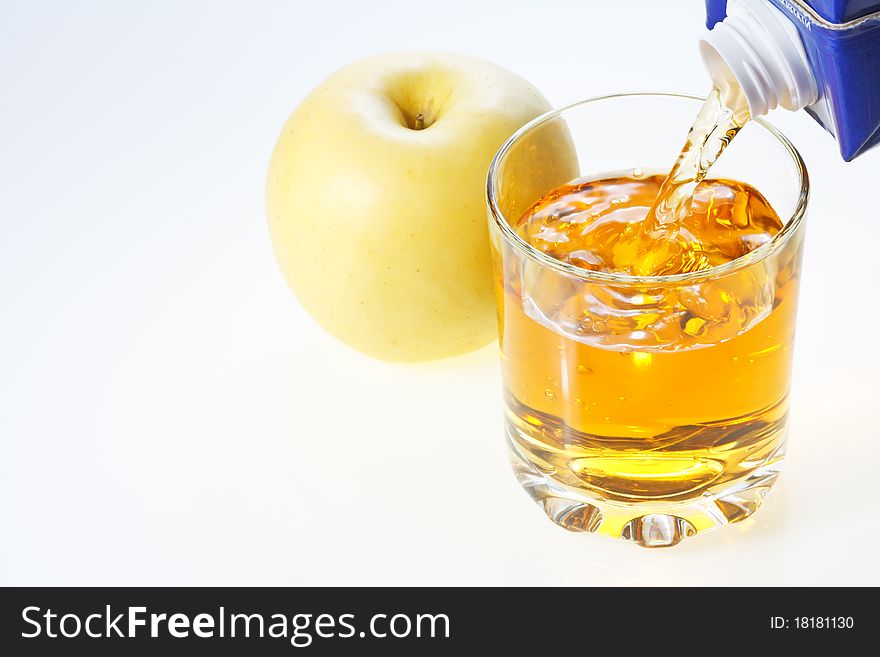 Yellow apple and glass filling with apple juice. Yellow apple and glass filling with apple juice