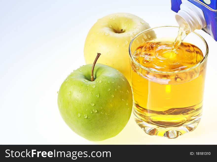 Green and yellow apples and glass filling with apple juice. Green and yellow apples and glass filling with apple juice