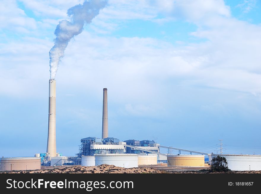 Smokestacks of power station on sky background