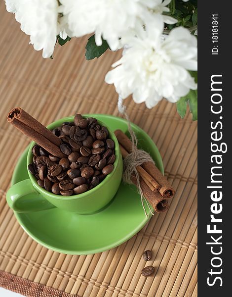 Coffee Beans In A Green Cup