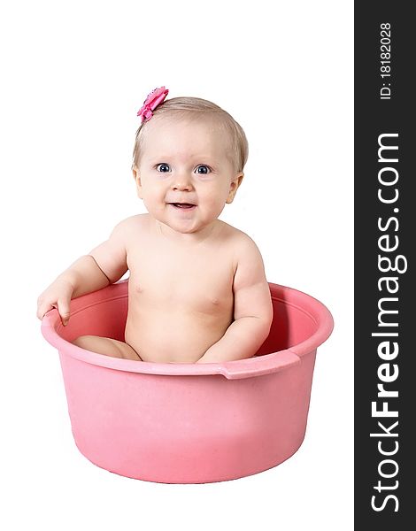 Cute baby having bath in pink tub