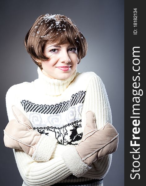 Young beautiful girl rejoices to snow, On a dark blue background