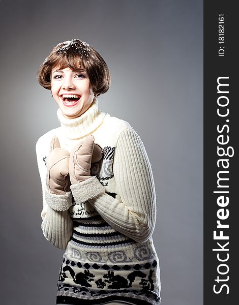 Young beautiful girl rejoices to snow, On a dark blue background