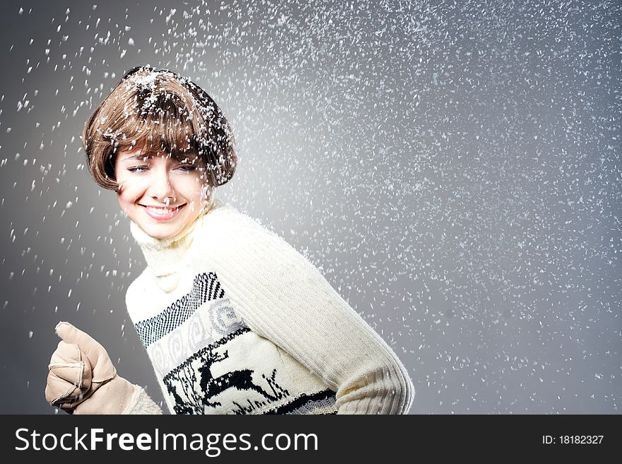 Young beautiful girl rejoices to snow, On a dark blue background