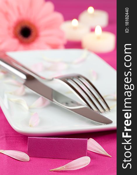 Place setting with candle, flower and tag. Place setting with candle, flower and tag