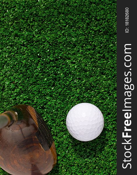 Golf Ball and driver on green grass