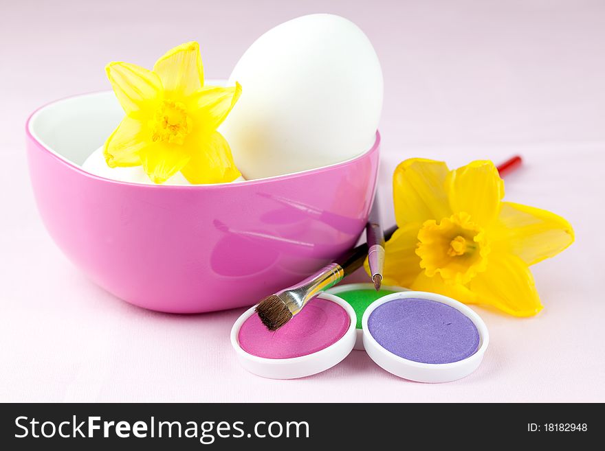 Eggs in a bowl with colors, brush and daffodil. Eggs in a bowl with colors, brush and daffodil