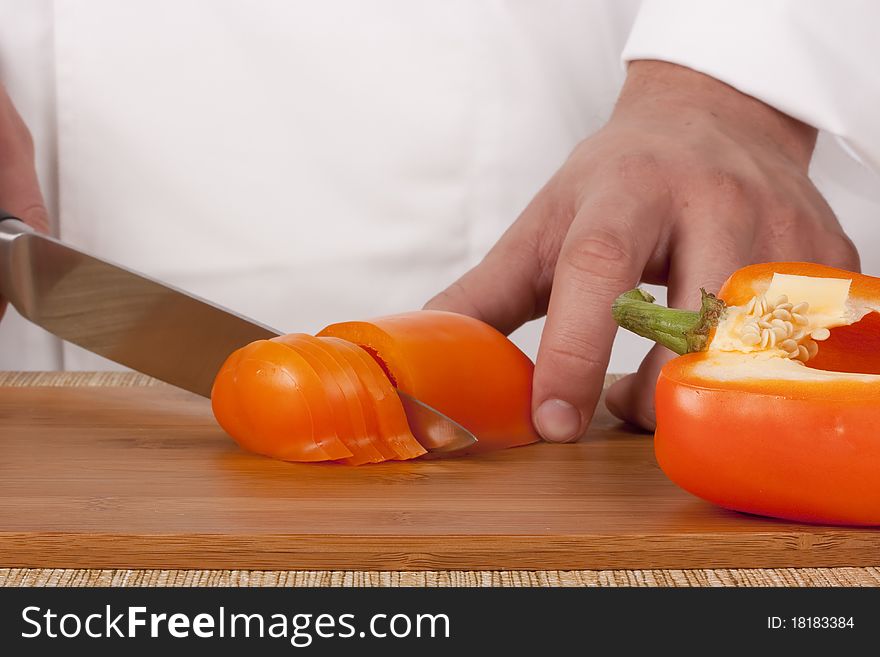 Chef Man cut vegetables on kitchen blackboard.