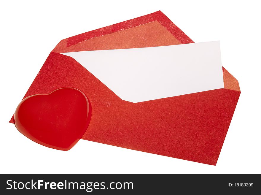 Red heart laying next to a red envelope with white paper on a white background. Red heart laying next to a red envelope with white paper on a white background.