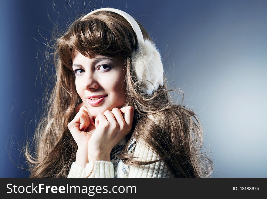 Young beautiful girl rejoices to snow, On a dark blue background